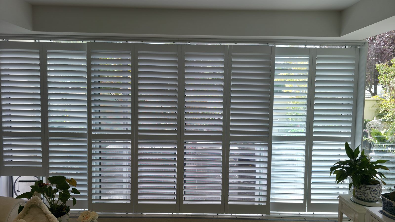 Lounge room bay windows fully shuttered for privacy and light control